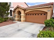 Inviting home featuring a two-car garage and a well-manicured front yard at 6339 Sharp Rock Ct, Las Vegas, NV 89139