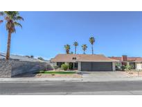 Charming single-story home featuring a well-maintained front yard and a two-car garage at 6842 Greengrove Dr, Las Vegas, NV 89103