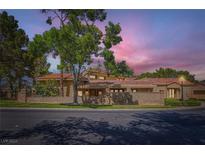 Charming single-story home featuring a red tile roof and mature landscaping at 7296 Mission Hills Dr, Las Vegas, NV 89113