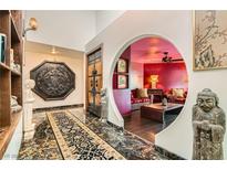Grand foyer featuring a unique circular archway and dark, patterned marble flooring at 7296 Mission Hills Dr, Las Vegas, NV 89113