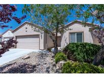 Charming single-story home featuring low-maintenance desert landscaping, neutral stucco, and an attached two-car garage at 7448 Lintwhite St, North Las Vegas, NV 89084