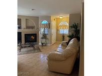 Inviting living room featuring a cozy fireplace and an abundance of natural light at 7950 W Flamingo Rd # 2074, Las Vegas, NV 89147