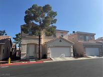 Charming two-story home features a well-manicured front yard and attached two-car garage at 971 Whispering Grove Ave, Las Vegas, NV 89123