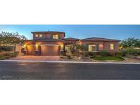 Charming two-story home featuring a three-car garage and a well-maintained landscaped front yard at 9760 Arch Canyon Ct, Las Vegas, NV 89149