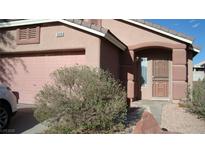 Charming single-story home with a stucco facade, arched entryway, and a well-manicured front yard at 10220 Arlington Abby St, Las Vegas, NV 89183