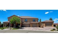 Spacious two-story home featuring a three-car garage and professionally landscaped front yard at 1182 Thomas Bay Cir, Logandale, NV 89021