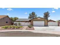 Charming single-story home with a well-maintained front yard and a two-car garage at 1520 Della Ct, Boulder City, NV 89005