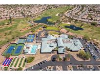 Expansive aerial view of community amenities featuring golf course, pool, clubhouse, and tennis and pickleball courts at 2185 High Mesa Dr, Henderson, NV 89012