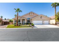 Charming single-story home with a three-car garage, mature palm trees, and a well-manicured lawn at 2543 Farmington Ave, Las Vegas, NV 89120