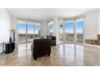 Bright living room features floor-to-ceiling windows with stunning city views and comfortable seating at 2777 Paradise Rd # 2605, Las Vegas, NV 89109