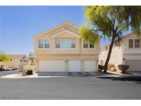Two-story condo with a three-car garage and manicured landscaping, perfect for modern living at 3041 Gary Cooper St # 103, Las Vegas, NV 89122