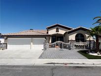 Charming single-story home featuring a gated entry, a three-car garage, and low-maintenance landscaping at 3064 Azure Bay St, Las Vegas, NV 89117