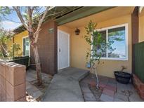 Inviting front entrance with a secure white door and well-maintained landscaping at 317 E Van Wagenen St, Henderson, NV 89015
