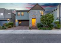 Beautiful two-story home featuring a stone facade and well-manicured landscaping at 3206 Fountaintree Ave, Henderson, NV 89044