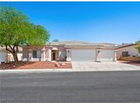 Charming single-story home with a three-car garage, well-maintained landscaping, and a neutral color scheme at 3431 Cottage Thistle Dr, Laughlin, NV 89029