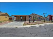 Charming single-story home with a covered parking and a well-maintained front yard in a suburban neighborhood at 3630 N Pecos Rd, Las Vegas, NV 89115