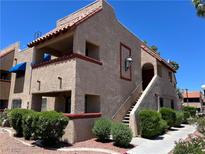 Charming two-story condo with stucco siding, a red tile roof, and well-maintained landscaping at 4121 Gannet Cir # 414, Las Vegas, NV 89103