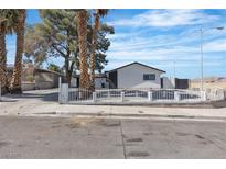 Charming home featuring a white picket fence, mature trees, and a well-maintained yard at 4186 Toronto Cir, Las Vegas, NV 89121
