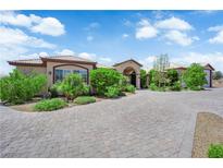 Beautiful single story home with a brick driveway and plenty of vegetation at 4455 W Ford Ave, Las Vegas, NV 89139