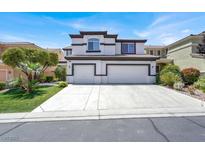 Two-story home featuring a three-car garage, stucco exterior, and a well-manicured lawn at 5785 Farmhouse Ct, Las Vegas, NV 89141