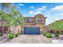 Inviting two-story home with a blue garage door, stone accents, and a well-maintained front yard at 6626 Seahorse Reef St, Las Vegas, NV 89149