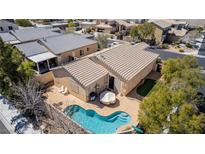 Aerial view of the kidney-shaped pool and patio area in the backyard of this single-story home at 8266 Lincoln Valley St, Las Vegas, NV 89123