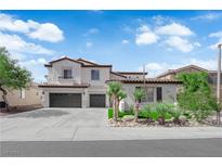 Inviting two-story home featuring a spacious driveway and desert landscaping, creating great curb appeal at 8268 Nelson Ridge Ln, Las Vegas, NV 89178