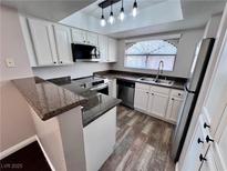 Well-lit kitchen with white cabinetry, stainless steel appliances, and granite countertops at 8455 W Sahara Ave # 213, Las Vegas, NV 89117
