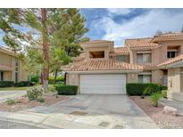 Charming townhouse featuring a two-car garage and manicured landscaping at 8591 Heather Downs Dr, Las Vegas, NV 89113