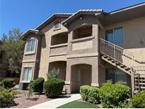 Inviting multi-story exterior showcasing a well-manicured lawn and convenient staircase access to upper-level units at 8805 Jeffreys St # 1103, Las Vegas, NV 89123