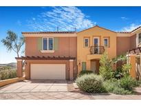 Charming townhome featuring stucco siding, an attached two-car garage, and well-manicured landscaping at 1 Cerchio Basso, Henderson, NV 89011