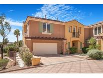 Beautiful two-story home with two-car garage, landscaped yard, and Spanish-style tile roof under bright blue skies at 1 Cerchio Basso, Henderson, NV 89011