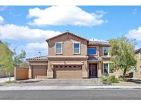 Two-story home featuring a three-car garage and well maintained landscape at 1020 High Altitude Ave, North Las Vegas, NV 89032
