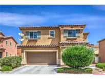 Two-story home featuring a tiled roof, a two-car garage, desert landscaping, and shuttered windows at 1420 Gilbert Creek Ave, North Las Vegas, NV 89031