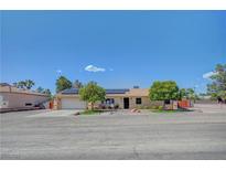 Charming single-story home with desert landscaping, solar panels, and a two-car garage at 1560 Arabian Dr, Henderson, NV 89002