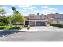 Beautiful two-story home with well-maintained landscaping, a three-car garage, and a spacious driveway at 188 Carthage St, Henderson, NV 89074