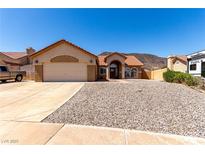 Charming single-story home with a spacious driveway and desert landscaping at 307 Oak Canyon Dr, Henderson, NV 89015