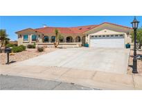 Charming single-story home features a tile roof, two car garage and low-maintenance desert landscaping at 3640 E Vineyard Dr, Pahrump, NV 89048
