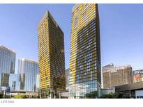 Modern high-rise condo building with stunning yellow glass exterior and city views at 3726 Las Vegas Blvd # 3202, Las Vegas, NV 89158