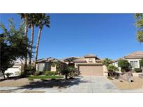 Charming single-story home featuring a well-maintained landscape, desert plants and a two car garage at 4299 Fiore Bella Blvd, Las Vegas, NV 89135