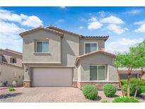 Charming two-story home with a brick driveway, two-car garage, and well-maintained landscaping at 4428 Mural Glen Ct, North Las Vegas, NV 89084