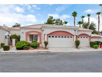 Charming home featuring a two-car garage, lush landscaping, and a welcoming entrance, perfect for suburban living at 5161 Briar Meadow Way, Las Vegas, NV 89118