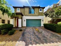 Two-story home featuring a two-car garage, tile roof, and beautiful desert landscaping in a well-maintained community at 5941 Galway Bay St, North Las Vegas, NV 89081