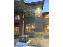 Two-story condo building with well-maintained landscaping and visible unit numbers, featuring multiple windows at 8000 Badura Ave # 1168, Las Vegas, NV 89113