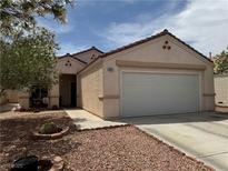 Charming single-story home with a two-car garage, desert landscaping, and a well-maintained stucco exterior at 9611 Sky Hollow Dr, Las Vegas, NV 89123