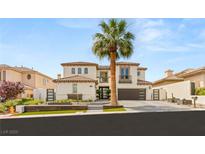 Elegant two-story home with a brown roof, complemented by a lush palm tree in the front yard at 11453 Glowing Sunset Ln, Las Vegas, NV 89135