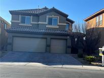 Charming two-story home featuring a two-car garage and well-maintained front yard at 117 Logan Pond Way, North Las Vegas, NV 89084