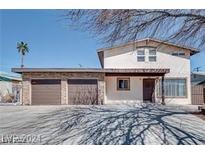 Two story home with a two car garage and covered front entryway at 1806 Renada Cir, North Las Vegas, NV 89030