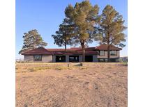 Spacious single-story home with red tile roof, gray exterior, and large bare front yard at 1967 N Moapa Valley Blvd, Logandale, NV 89021