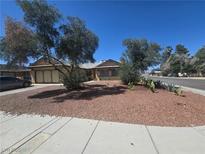 Charming single-story home featuring mature trees and low-maintenance desert landscaping in the front yard at 2921 Mitzi Ave, Las Vegas, NV 89101